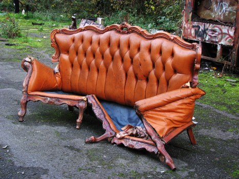 Workers conducting risk assessment near skip on roadside